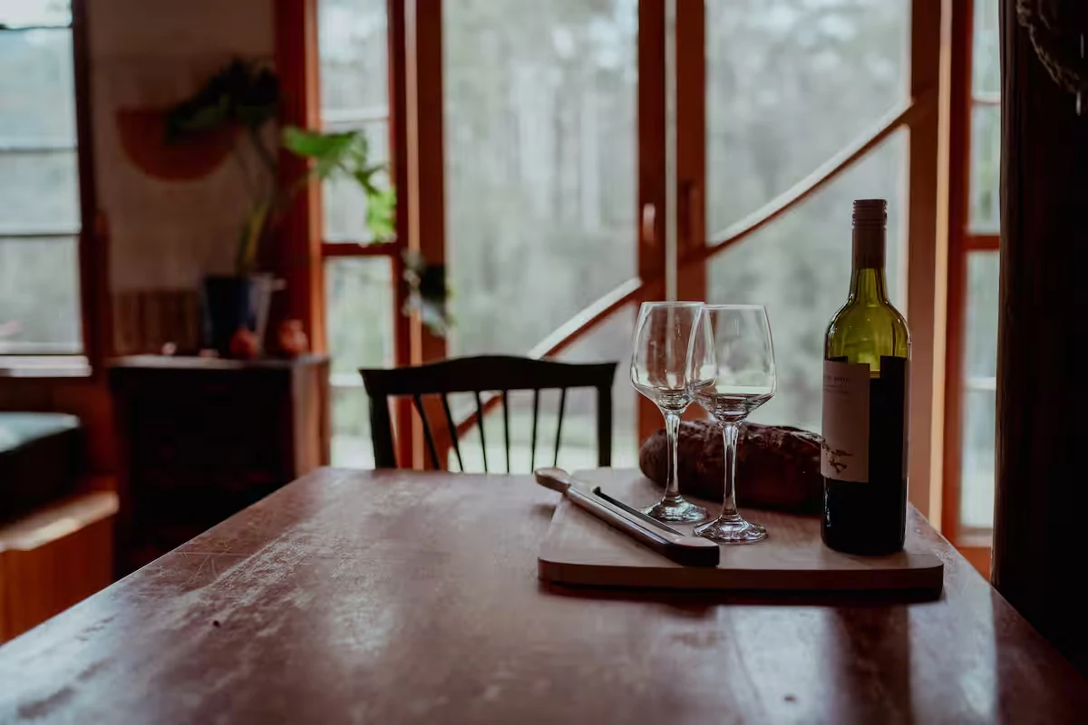 Wine and glasses on the dining table by the window